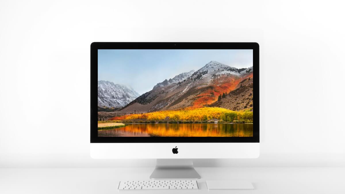 silver imac and magic keyboard on white surface