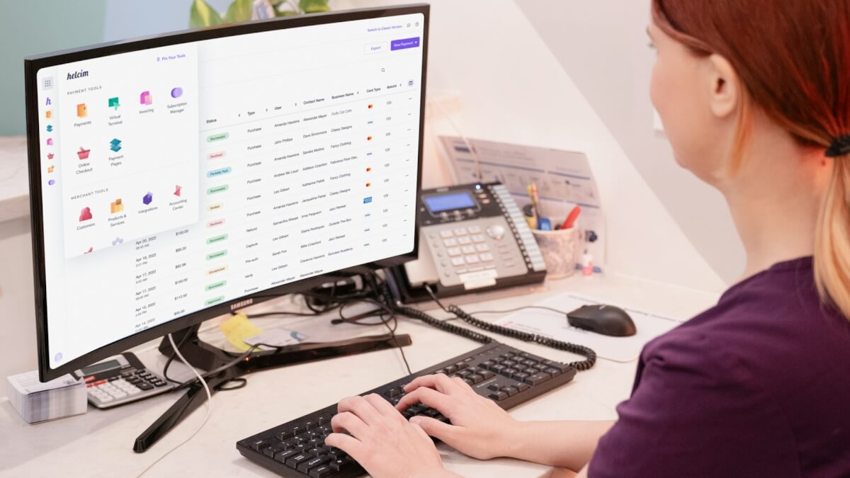 a woman sitting at a desk using a computer