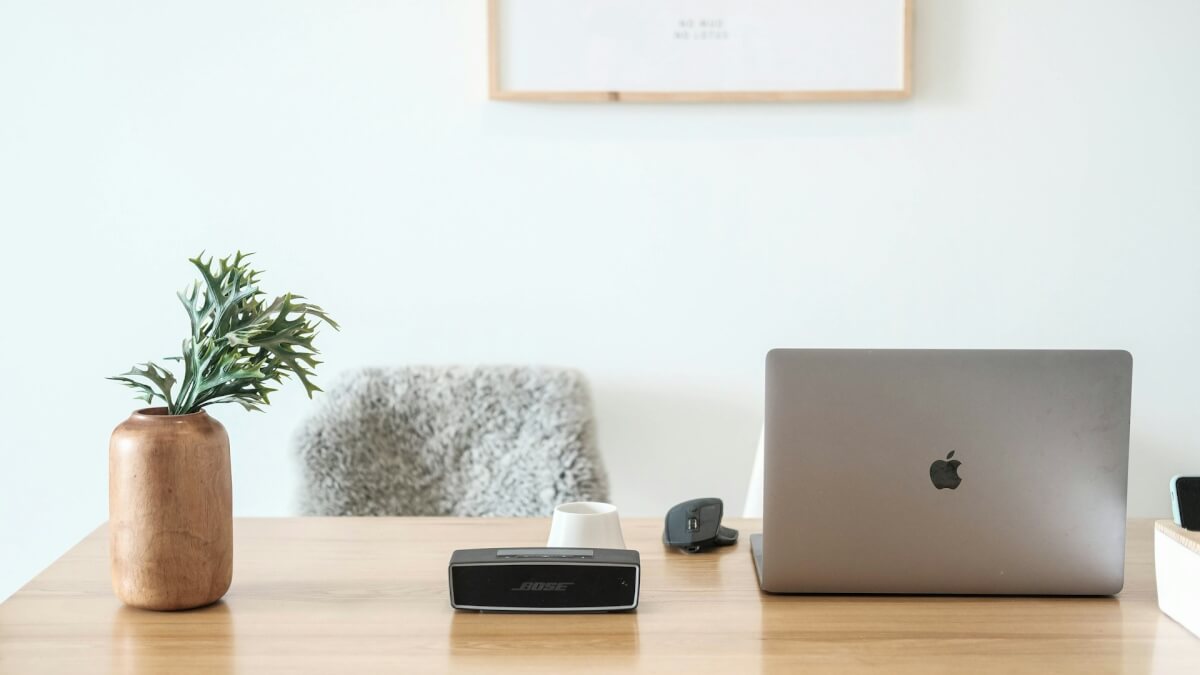 macbook pro on brown wooden table