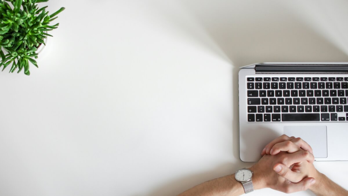 person wearing watch near laptop