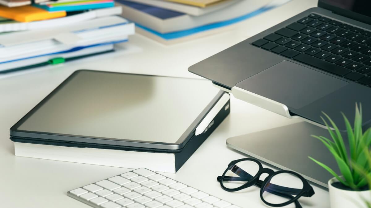 laptop computer sitting on top of a white desk