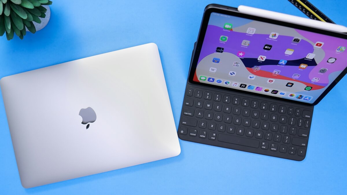 silver macbook beside black tablet keyboard