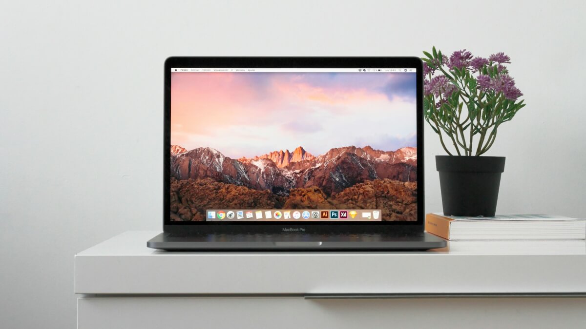 MacBook on top white table