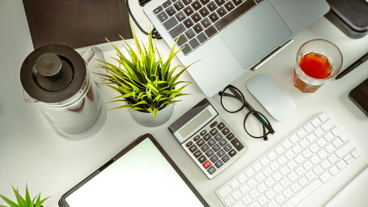 a laptop computer sitting on top of a white desk