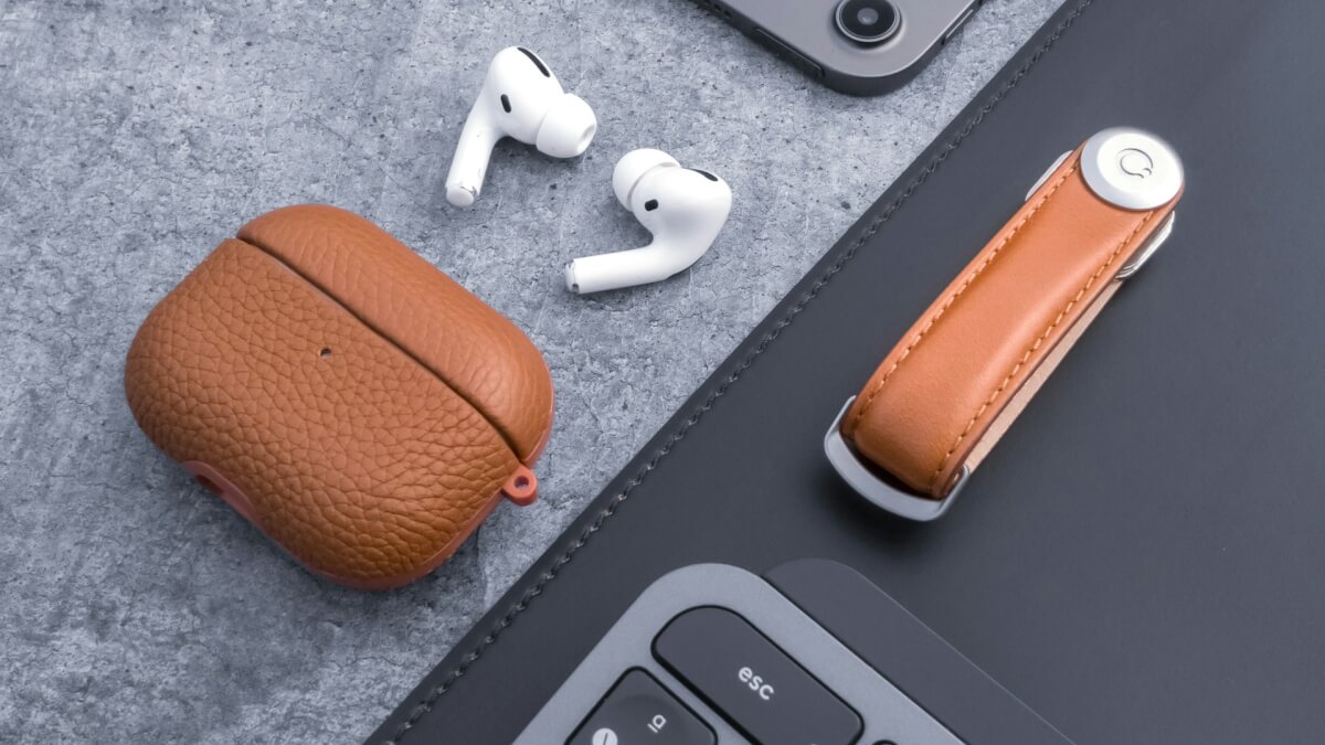 a pair of ear buds sitting next to a laptop