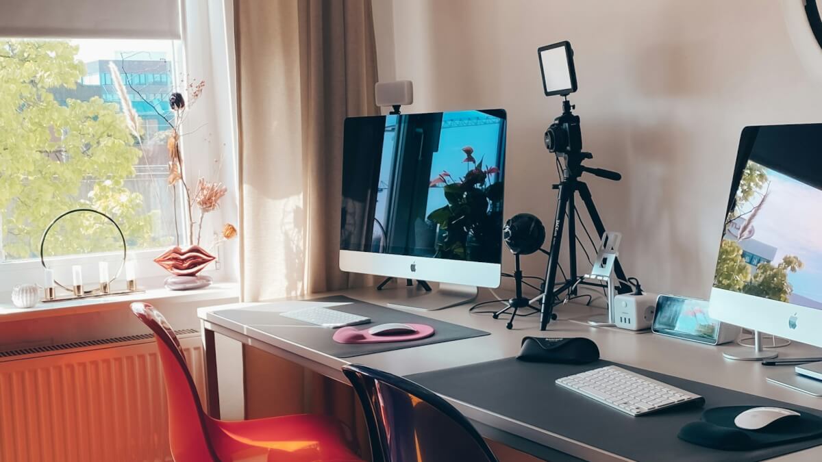 black flat screen computer monitor on white wooden desk