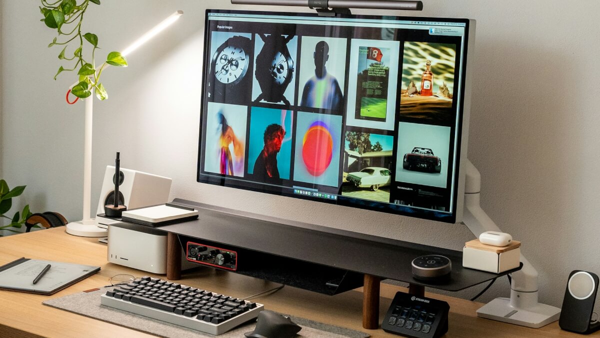 computer monitor sitting on top of a wooden desk