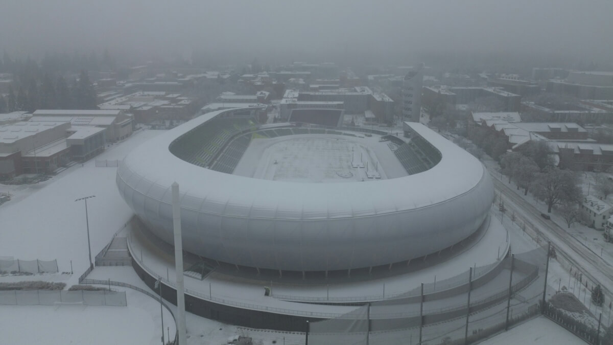 an aerial view of a snow covered stadium