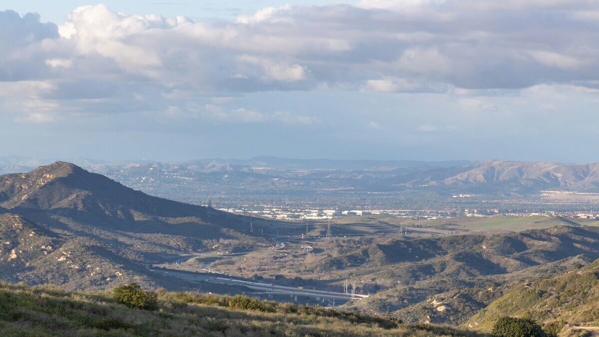 a view of a valley with mountains in the distance