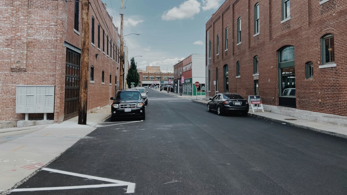 cars parked in front of brown building during daytime