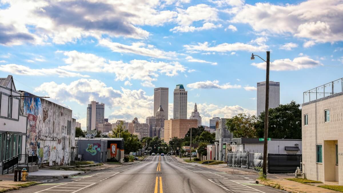 an empty street with a few buildings in the background