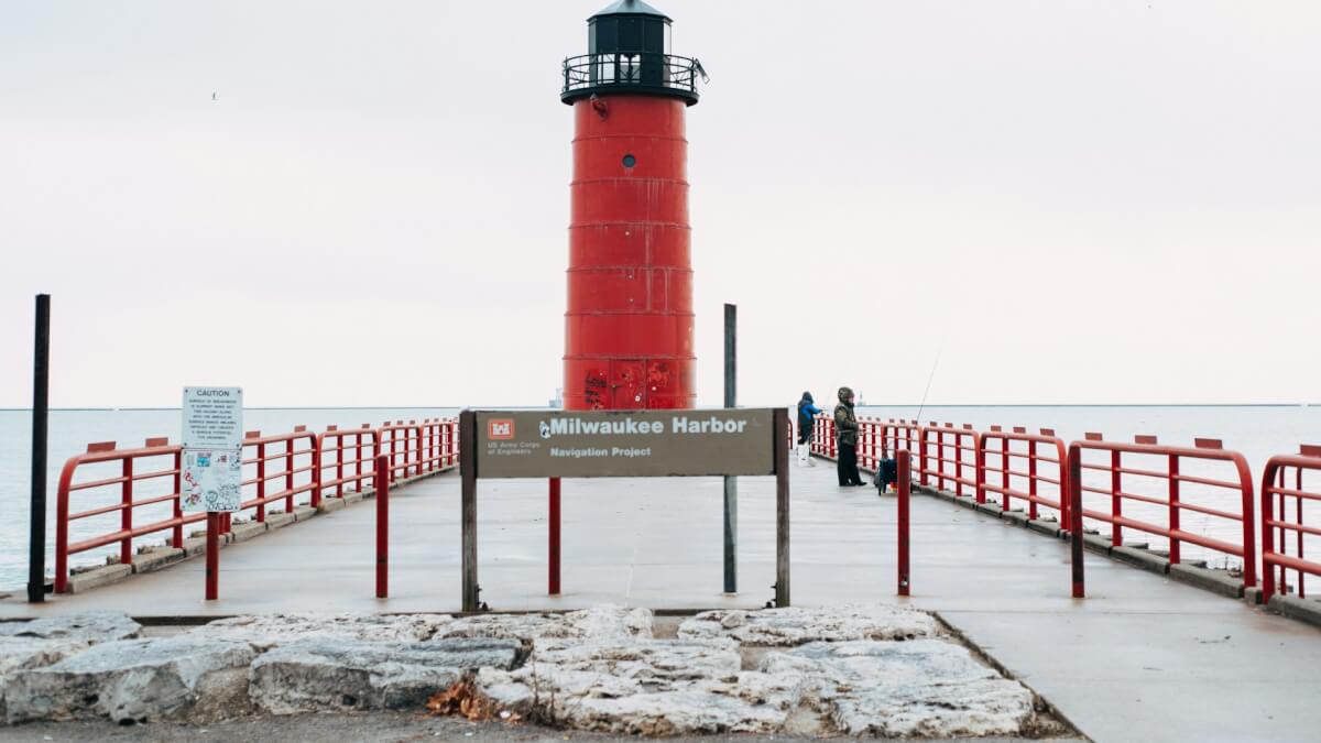 red and white lighthouse near sea during daytime