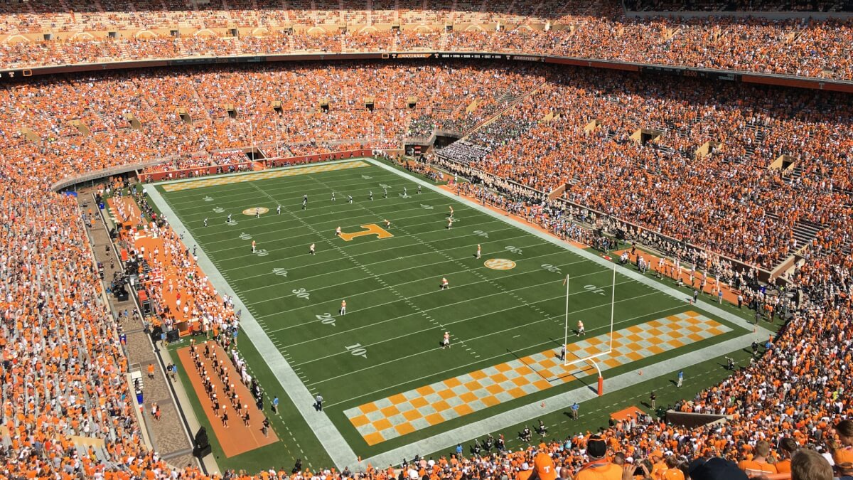 green football field under blue sky during daytime