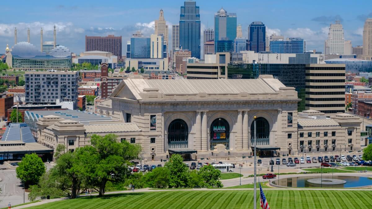 a large building with a pool in front of it with Union Station in the background